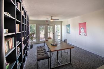 a dining room with a table and chairs and a bookshelf at Woodland Crossing , Woodland California